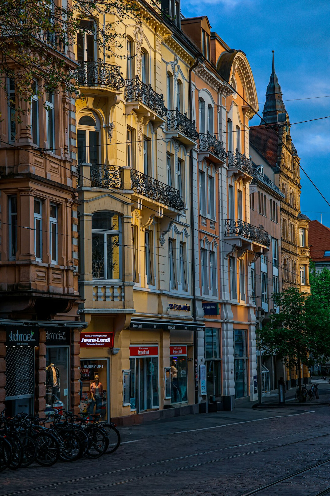 Old European street with historic townhouses at dusk